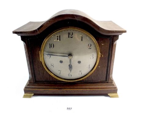 An oak arch top mantel clock 
