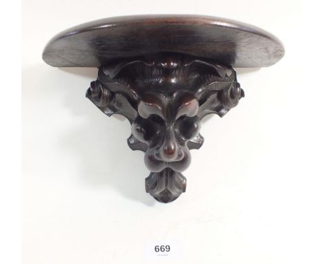 A Victorian carved mahogany bracket in form of a lions head, 17cm tall