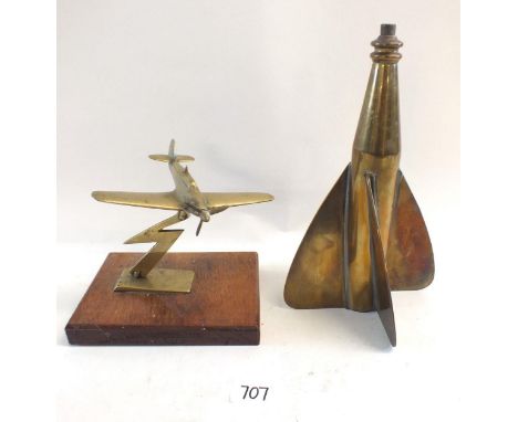 A brass model spitfire on mahogany base and a brass ships speed log 