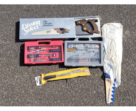A collection of boxed unused hand tools to include chisels and a Disston saw. 