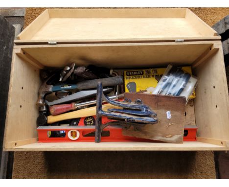A wooden toolbox containing  a collection of carpenters tools. 