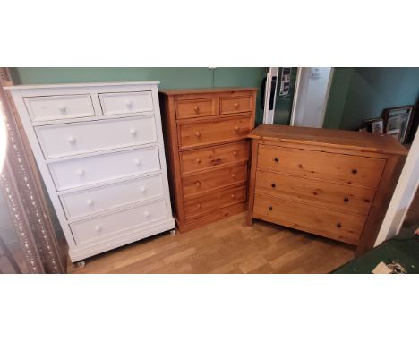 A modern pine three height chest of drawers, W110, D51, H97cm, together with a pine five height chest of drawers and a white 