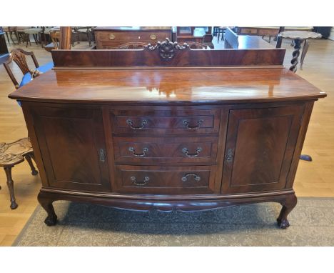 A Victorian mahogany bow framed sideboard, the raised back, over three central drawers, flanked by two cupboards opening to w