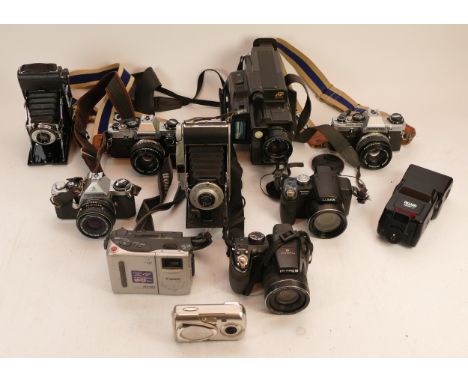 A Collection of cameras, to include 2x Olympus OM-10, Pentax ME, a Sanyo camcorder, 2x digital bridge cameras, etc