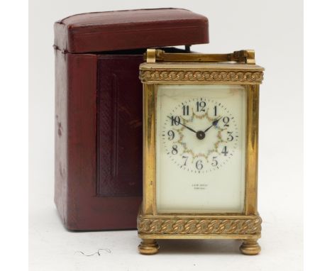 An early 20th century French brass carriage clock, painted porcelain dial with Arabic numerals and blued steel hands, the 8 d