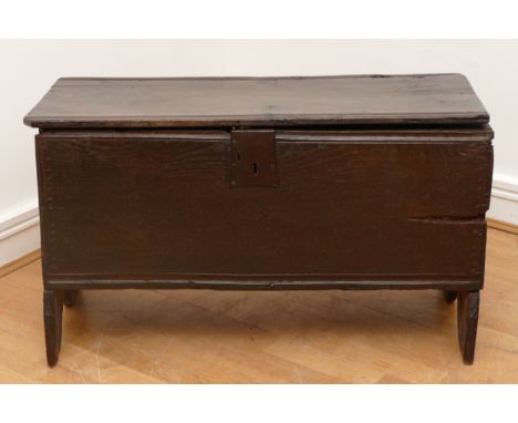 An 18th century oak six plank chest, the hinged top, panelled front and sides on stile supports, H49, W83, D34cm.