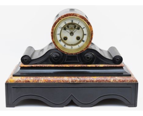 A late 19th century French black slate and variegated marble drum mantel clock, the dial with visible escapement, the S. Mart