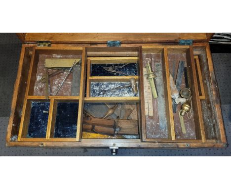 A large wooden tool box, containing an assortment of wares,  including a boxwood ruler.