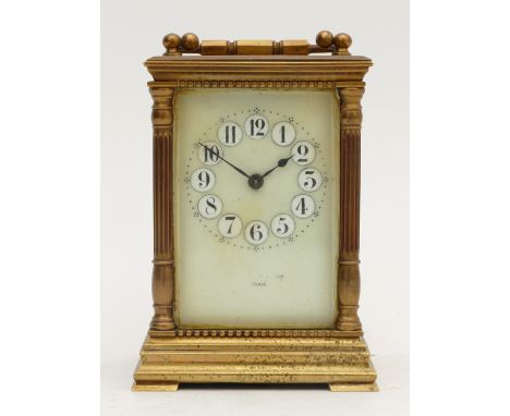 A late 19th century French gilt brass carriage clock, the cream porcelain dial with painted Arabic numerals and blued steel h