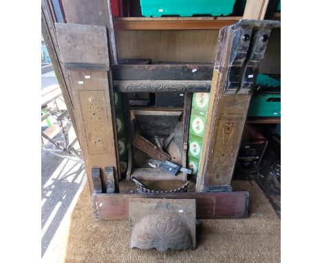 A cast iron tiled fire place containing green coloured ceramic tiles each depicting a floral motif., overall measurement 960m