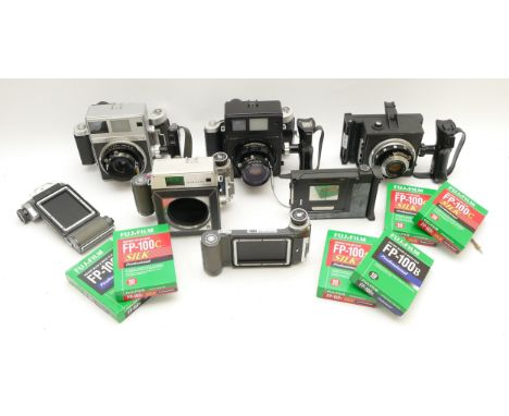 A collection of four vintage Mamiya camera bodies to include a Super 23 and a Standard 23, with a selection of boxed instant 