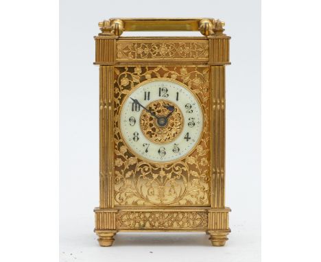 A late 19th Century gilt brass carriage clock, cream enamel dial with Arabic numerals, pierced gilt trailing vine and grape d