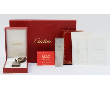 Cartier, a brushed stainless steel and gold screw gas lighter, numbered E 72746, dismantled, case, with booklets, Cartier fli