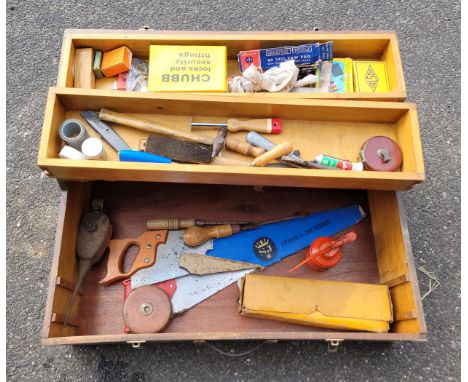 A toolbox containing a collection of carpenters hand tools. 
