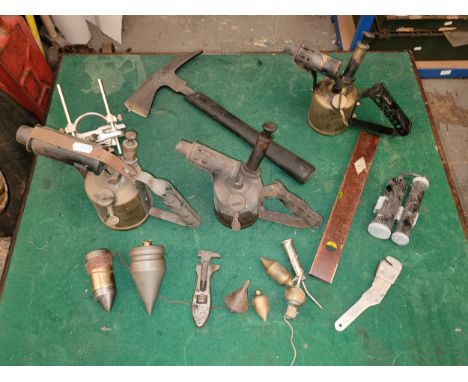 An assortment of good quality tools, to include plumb bobs, record plough plane, fireman's axe, and three blow torches, among