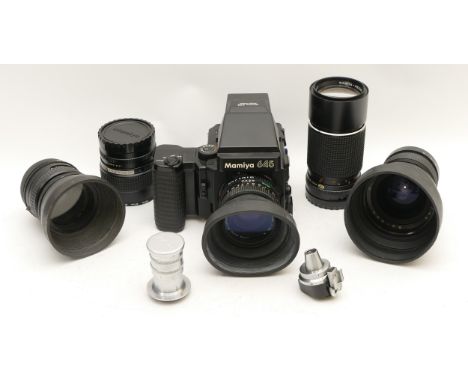 A Mamiya 645 vintage camera with four lenses and manual, serial number 209804