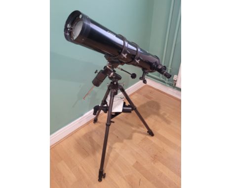 A Jessops refractor telescope, model TA900-114EQ, mounted on adjustable tripod, with Protocol lens/eyepieces and instruction 