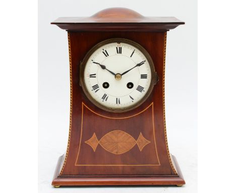 An Edwardian mahogany and boxwood inlaid mantel clock, inset with shells, the unsigned movement lacking a pendulum, striking 