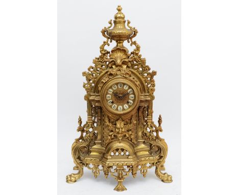 A 20th century large and ornate brass mantel clock, with heavy floral case and vase surmount, the German Hermle 130-070 movem