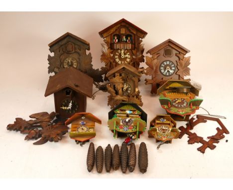 A collection of Black Forest cuckoo clocks, having two train manual wind movements, together with Austrian novelty wall clock