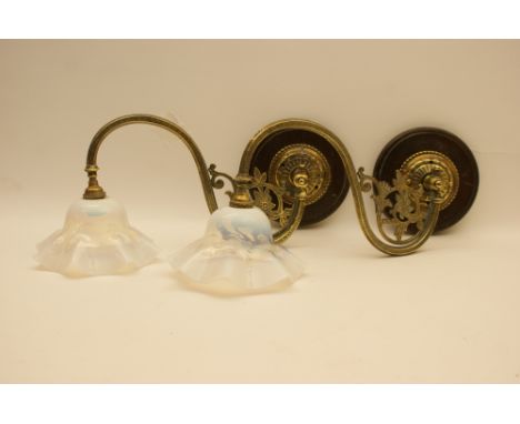 Pair of late Victorian brass bracket form wall lights, converted to electricity, having S-shaped swivelling arm supporting bl