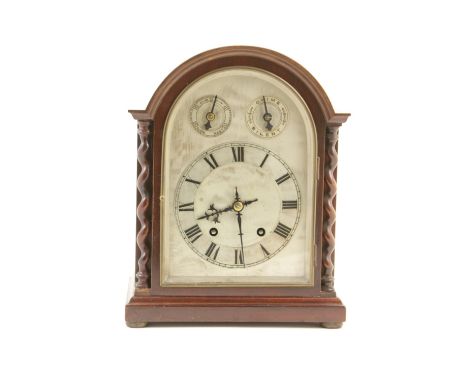 George V mahogany bracket mantel clock, domed case with barleytwist columns flanking a silvered arched dial with Roman numera