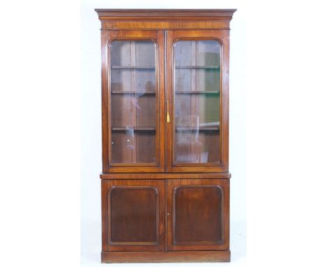 Victorian mahogany library bookcase, circa 1870, the top with moulded cornice over two moulded panel glazed doors, opening to