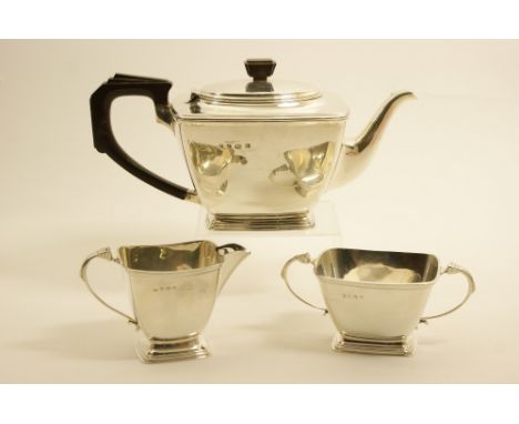 Late Art Deco silver three piece tea service, Birmingham 1939/40, comprising teapot of plain form with stepped bakelite handl