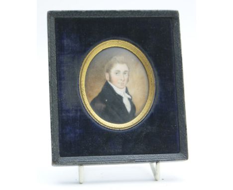 English School (early 19th Century), Portrait miniature of a gentleman in a black jacket, on ivory, with hair inset locket ba