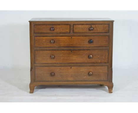 Late George III oak and mahogany banded chest of drawers, having canted corners with boxwood line inlays, flanking two short 