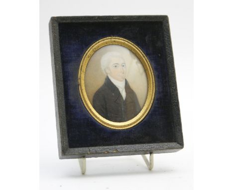 English School (Early 19th Century), Portrait miniature of a gentleman in a black jacket, half length, on ivory, with blue la