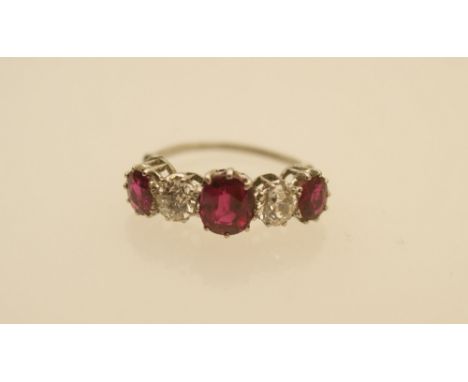 Ruby and diamond five stone ring, the central oval cut ruby approx. 1ct flanked by two old brilliant cut stones approx. 0.4ct
