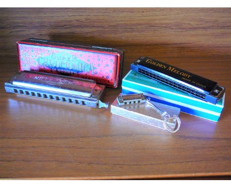 Hohner Chromatic Harmonica and two others.