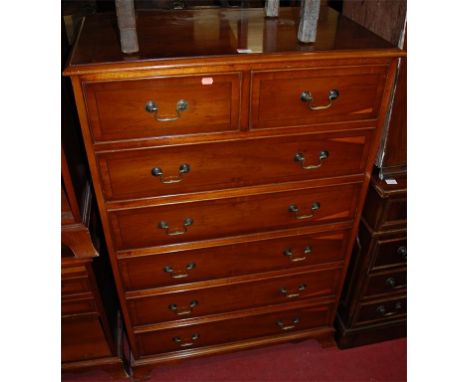A reproduction yew wood chest of two short over five long drawers, together with a pair of reproduction yew wood bedside ches