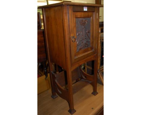 An Art Nouveau walnut pot cupboard having integral lower book trough