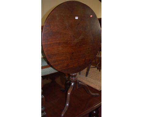 An early 19th century mahogany tilt top tripod table