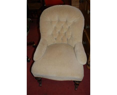 A Victorian walnut framed and button back upholstered nursing chair