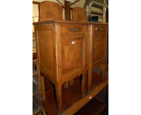 A pair of provincial French 19th century figured walnut and marble inset ledgeback single door bedside cupboards, each having