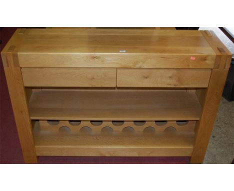 A modern G-Plan light oak two drawer side table, having lower interior wine rack 