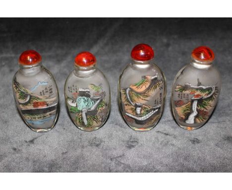 A set of four Chinese contemporary glass snuff bottles reverse painted with the Great wall of China and calligraphy, 8cm long