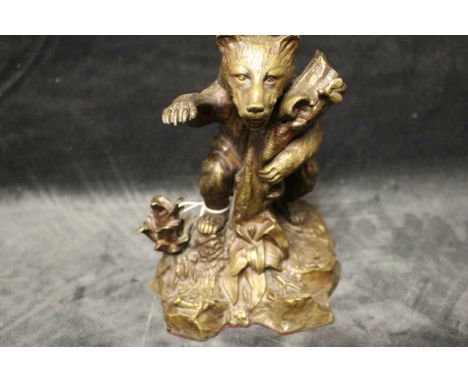 A 19th century style bronze inkwell modelled as a bear by a tree stump, the head forming the hinged cover, 17cm high