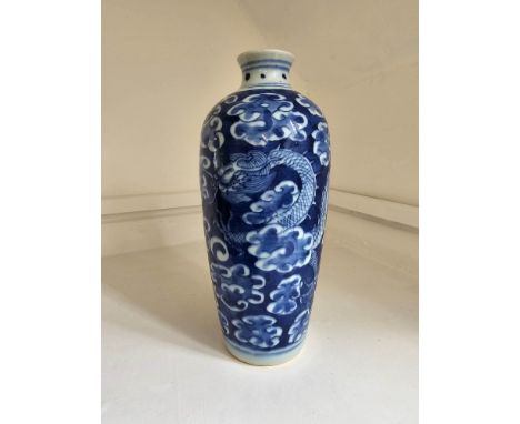 A Chinese Blue and White Dragon vase. Depicting a four clawed dragon moving through clouds chasing a pearl. Circa late 19th c