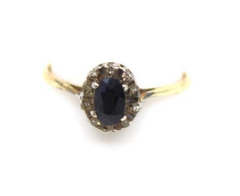 9ct Yellow Gold Sapphire and Diamond Ilusion Set Dress Ring.  The Oval Brilliant Cut Sapphire measures approx. 6mm x 4mm.  Th
