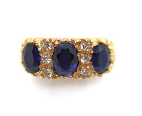 9ct Yellow Gold Synthetic Sapphire and Cubic Zirconia Ring  The ring contains three Oval Brilliant Cut Synthetic Sapphires. T