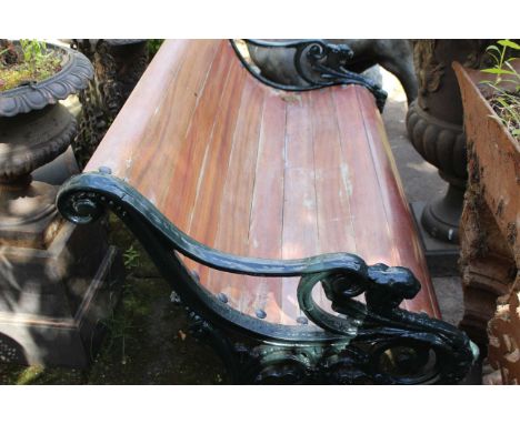 A garden bench with green painted cast iron ends. Approximately 142cm wide.&nbsp;