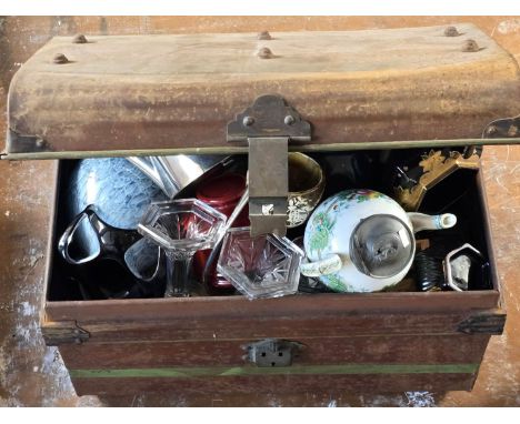 A vintage tin trunk containing a mixture of ceramics, glassware and assorted items