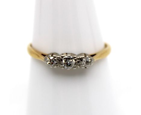 18ct Yellow Gold and Platinum Three Stone Trilogy Diamond Ring  The ring contains three Round Brilliant Cut Diamonds. The cen