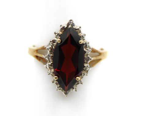 9ct Yellow Gold Garnet and Diamond Ring  The ring contains a Marquise Shaped Garnet that measures approx. 15mm x 7mm.  The ri