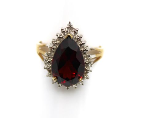9ct Yellow Gold Garnet and Diamond Ring  The ring contains a Pear Shaped Garnet that measures approx. 14.50mm x 9mm.  The rin
