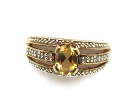 9ct Yellow Gold Citrine and Diamond Dress Ring  The ring contains an Oval Brilliant Cut Citrine that measures approx. 7mm x 5